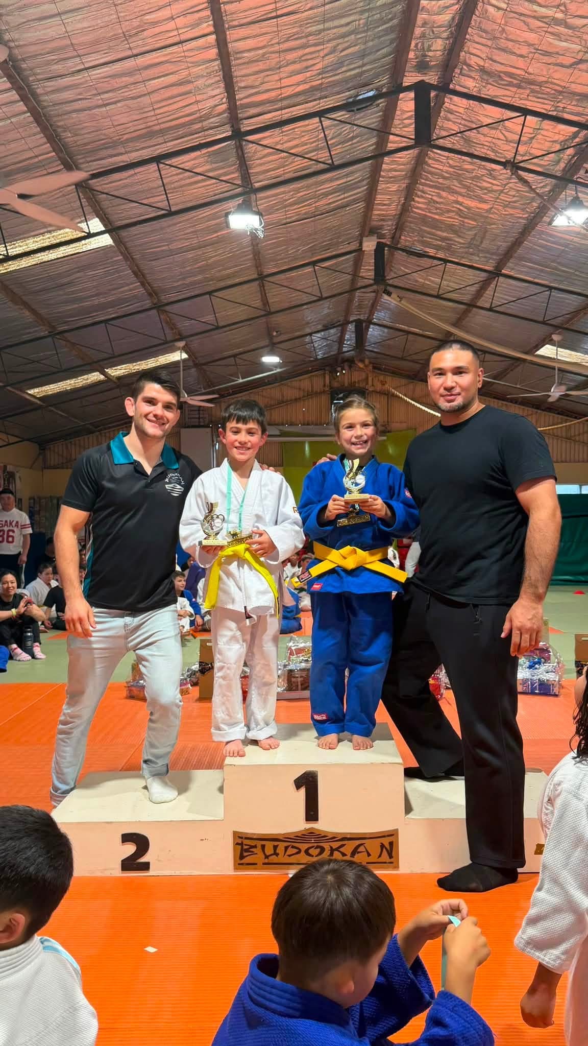 Young athletes celebrating with their coaches