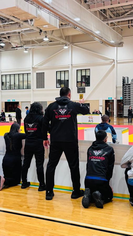 Respect Judo Academy coaches courtside at a competition