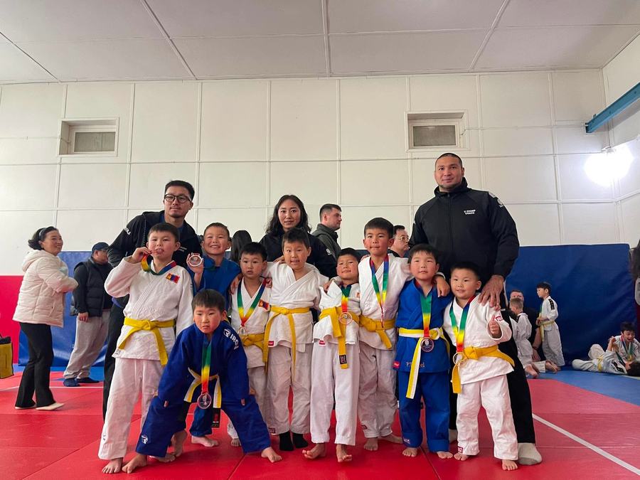 Respect Judo Academy students with coaches and medals